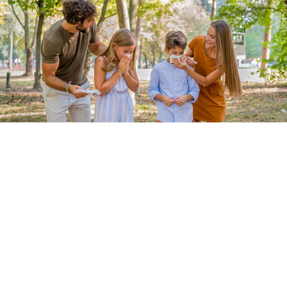 family spending time outside with kids blowing their noses