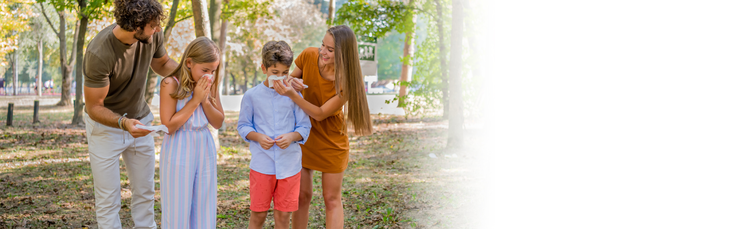 family spending time outside with kids blowing their noses