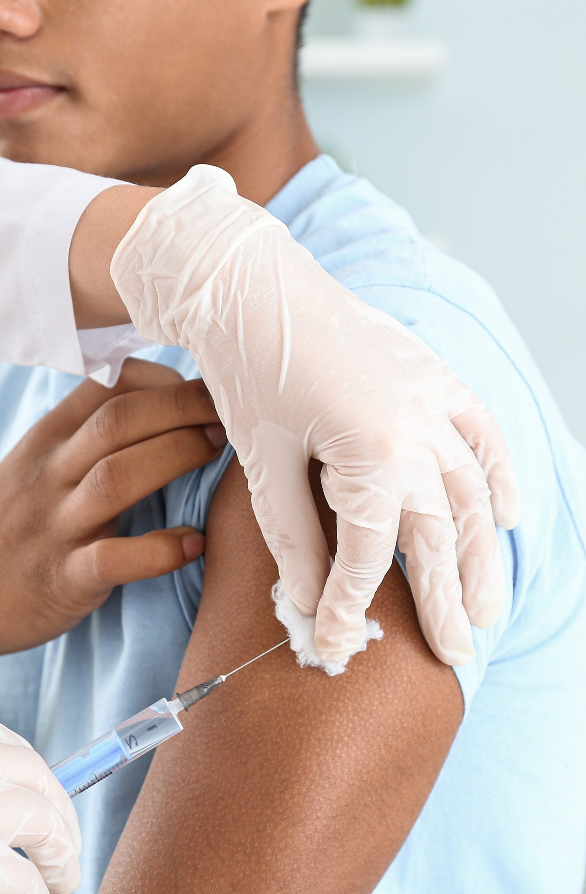Nurse giving a flu shot in a patient's arm